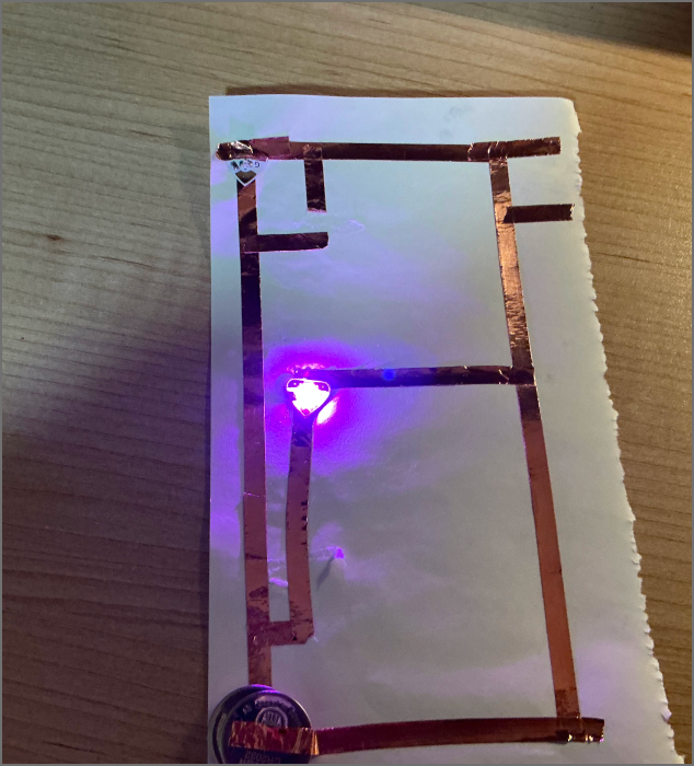 A circuit lit with a purple LED.