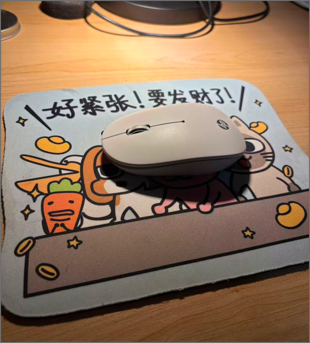 A cartoon mouse pad with a wireless mouse.