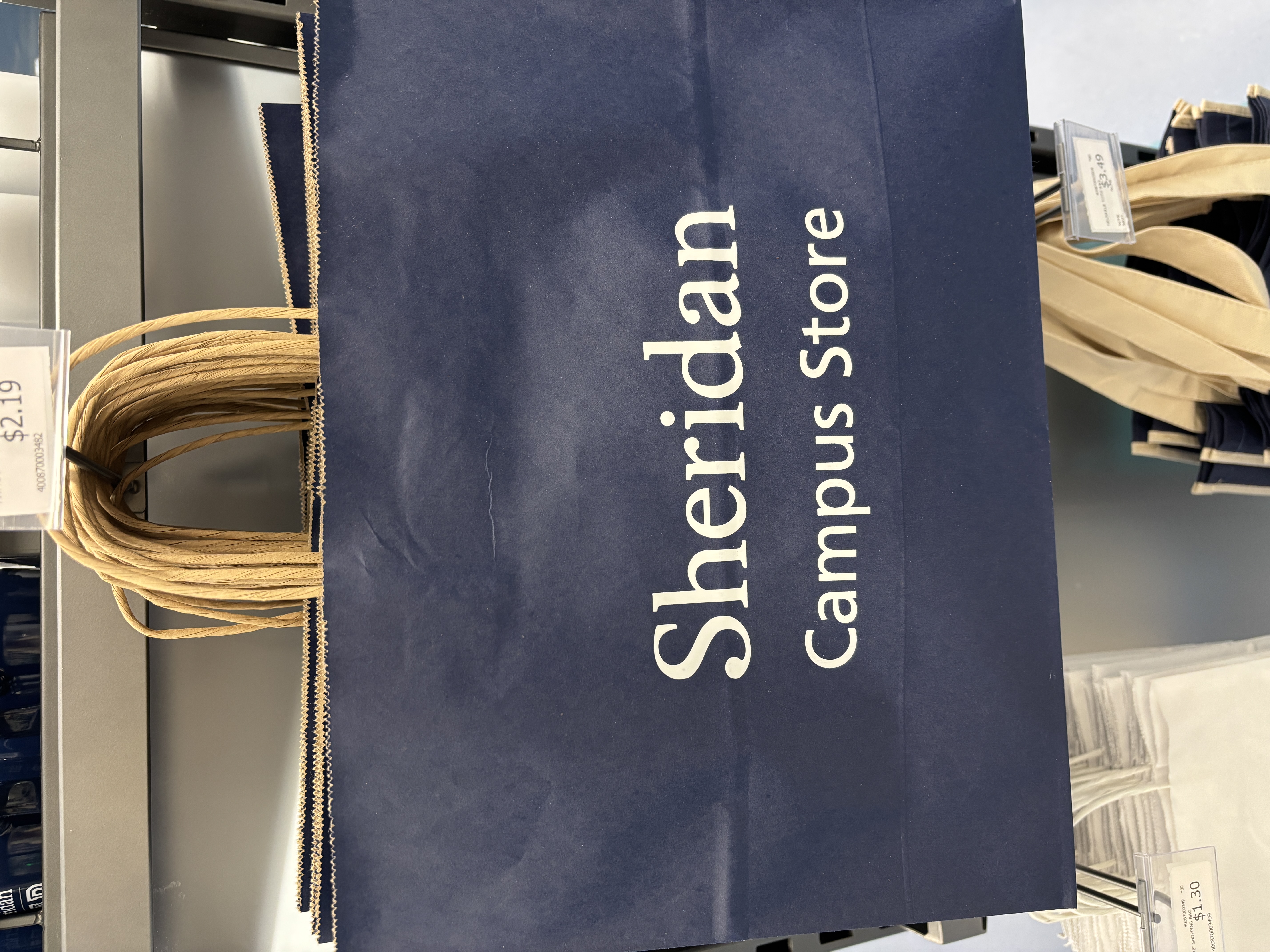 Campus store shopping bag that makes a rustling sound when handled or lifted.