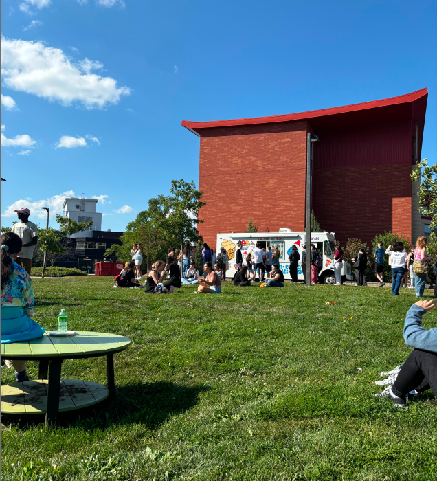The photo shows a side view of the school's Dormitory Building 1 under normal weather conditions.