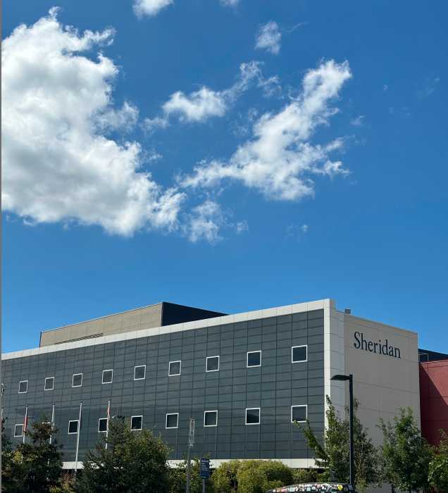 The photo shows the exterior of the school's J Building.