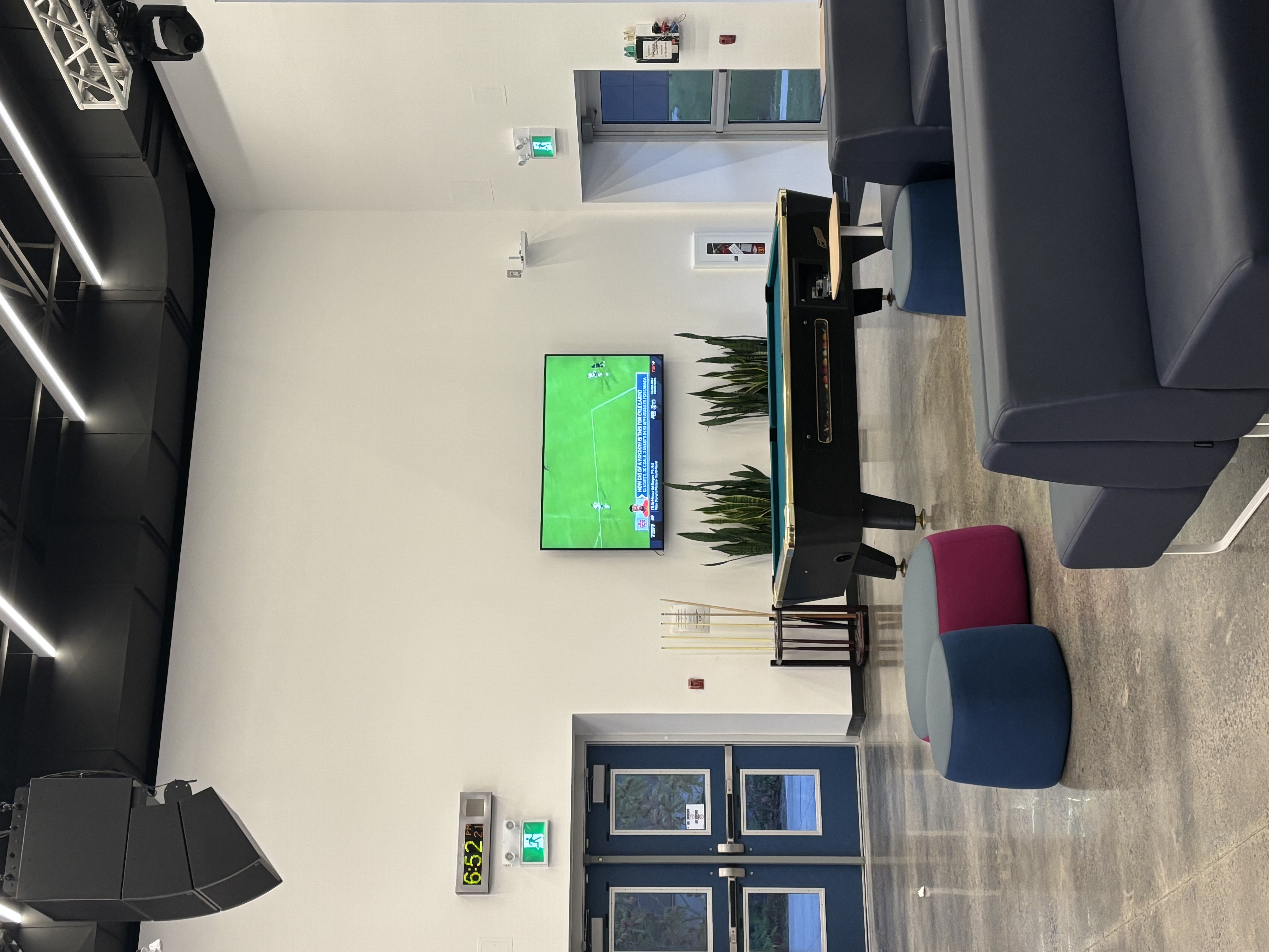 The scene depicted in the photograph is located in the northeast corner of the first floor interior within the SSU building at Sheridan School. It includes a pool table for student relaxation, a television, a decorative plant, and numerous chairs.<a href='https://www.youtube.com/embed/tgbNymZ7vqY' target='_blank'><p>Project Video Link</p></a>